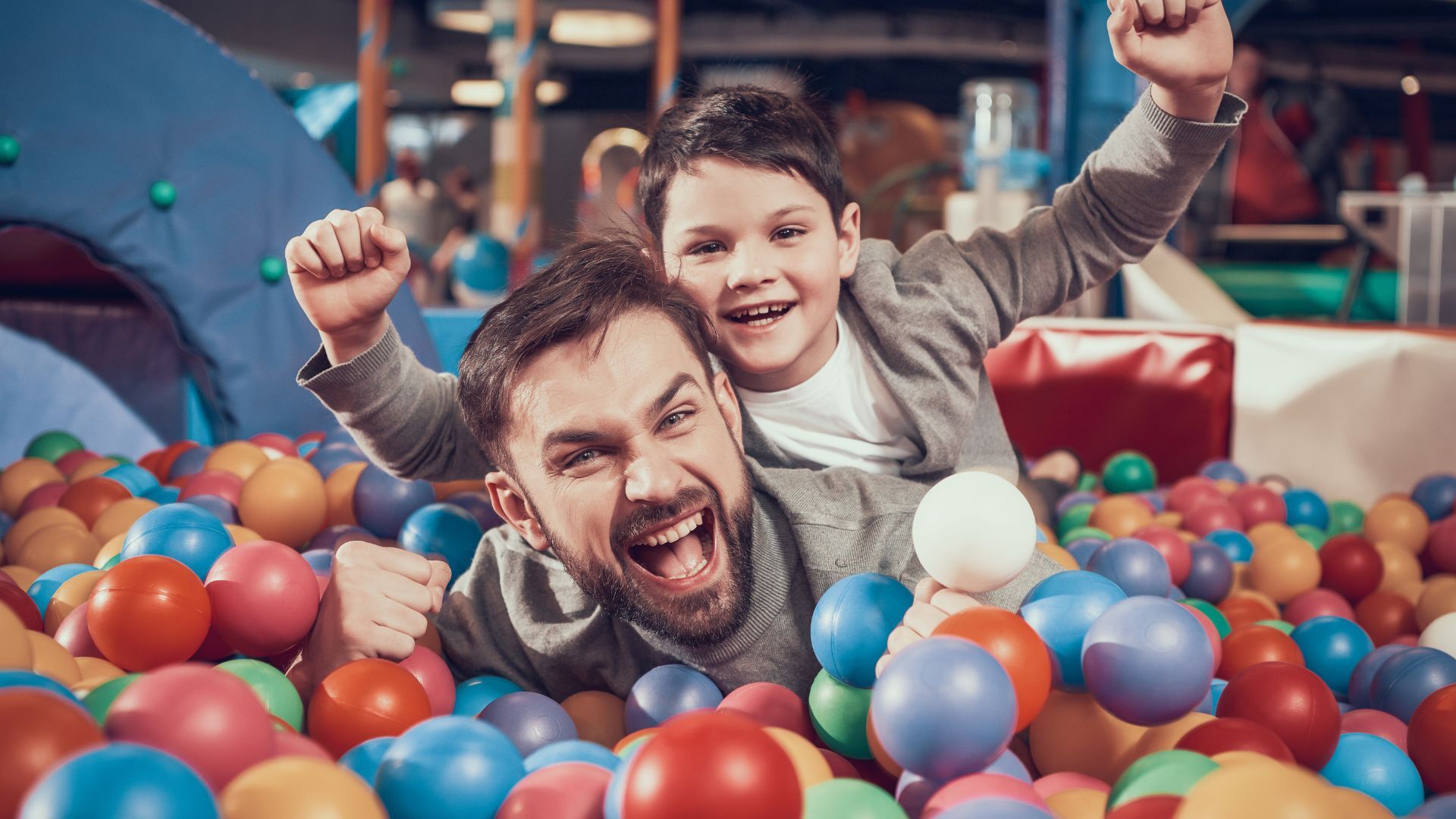 family having fun in a ball pit at an fec
